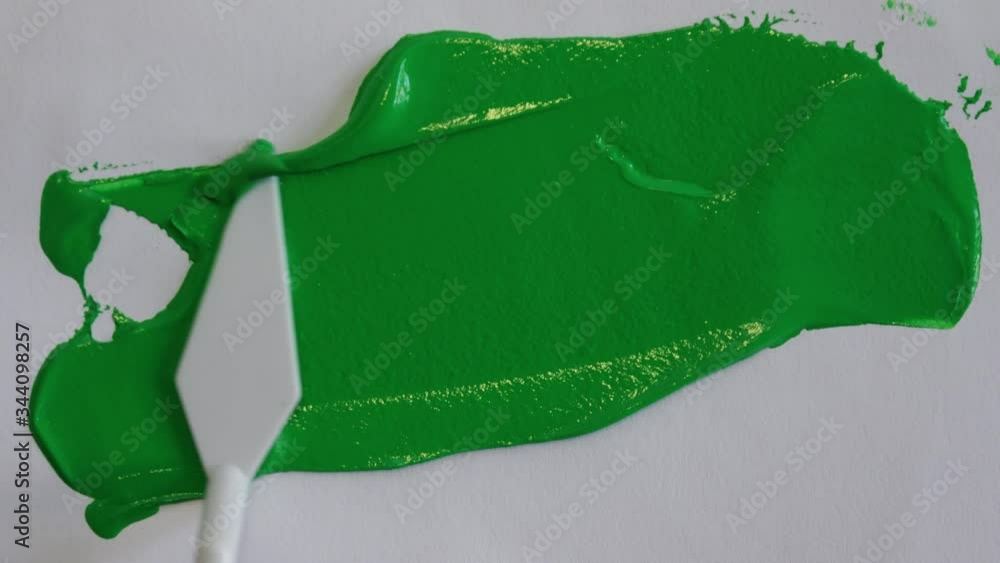 Spatula Spreading Green Screen Paint On Canvas, Chroma Key. Spatula spreading chroma key color