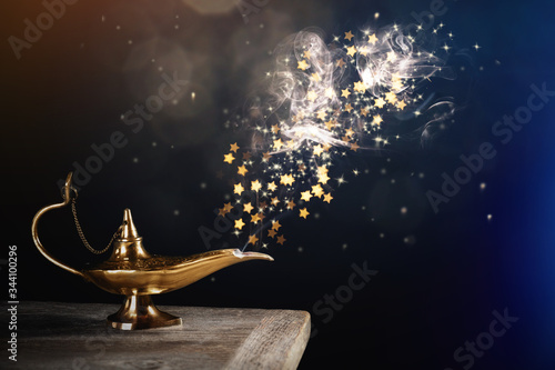 Genie appearing from magic lamp of wishes. Fairy tale photo