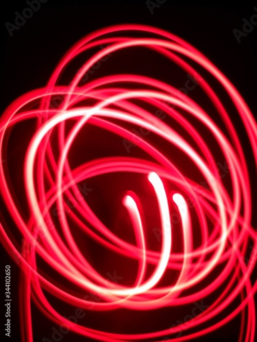 Abstract red spiral illumination design using red light under darkness 