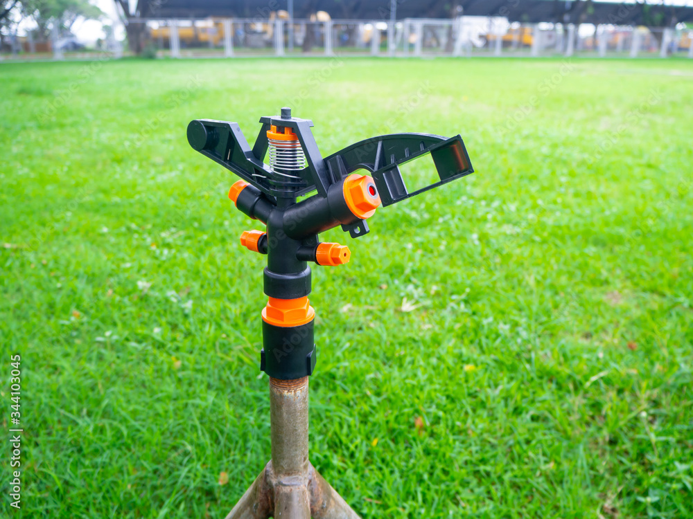 Springer is doing Watering plants and lawns in the garden Springer is doing Watering plants and lawns in the garden