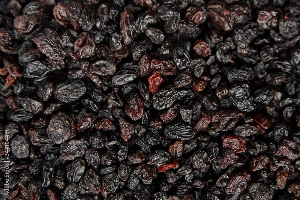 Raisins texture background. Heap of dried red grapes Raisins texture background. Heap of dried red grapes