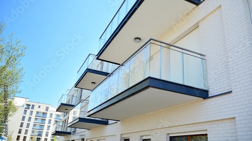 Residential Building on sky background. Facade of a modern housing construction with of balconies. © Grand Warszawski