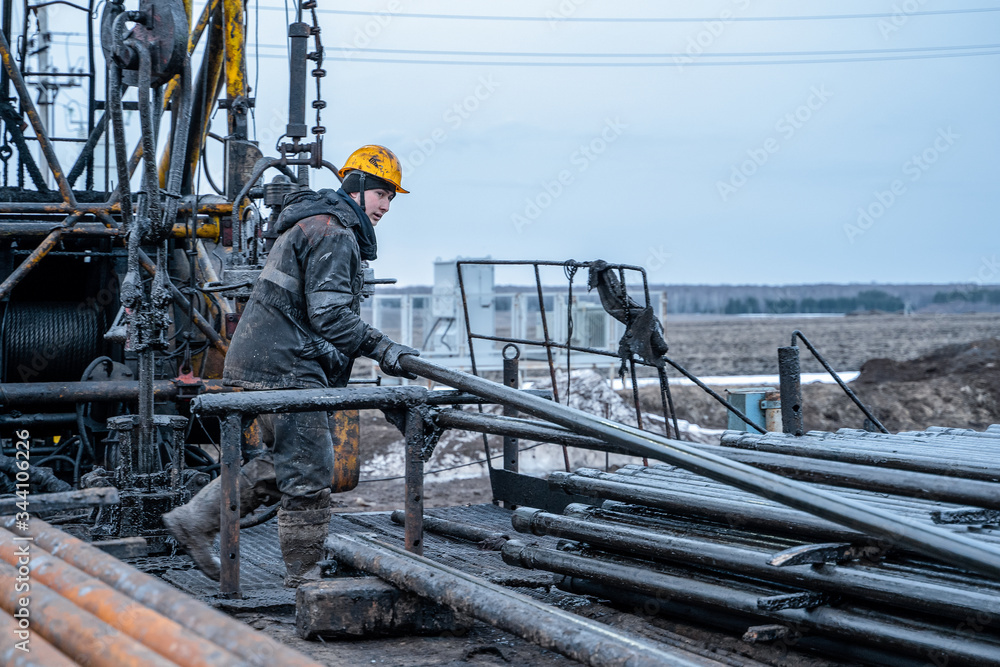 Workover rig working on a previously drilled well trying to restore ...