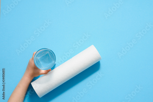 child's hand holds a glass of water. clean water concept. Filters for water purification at home