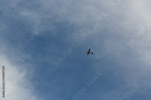 small plane flying low in the sky with space for text 