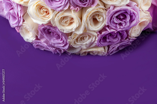 Bouquet of fresh amazing white and purple roses for postcard, cover, banner. Beautiful flowers as gift for Mother’s, Valentine’s Day, Birthday or Wedding. Copy space for text, soft focus photo