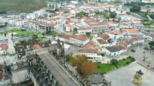 Aerial shot of ancient monastery and surrounding town on rainy day photo