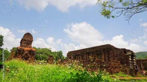 Mỹ Sơn Hindu Temple Ruins in tall grass and clouds in the background photo