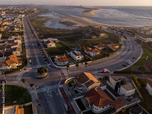 The marginal riverside, along the mouth of the Cavado River at sunset in Esposende, Portugal. The two sides of Restinga de Ofir. One facing the ocean, the other the estuary of Cávado River. photo