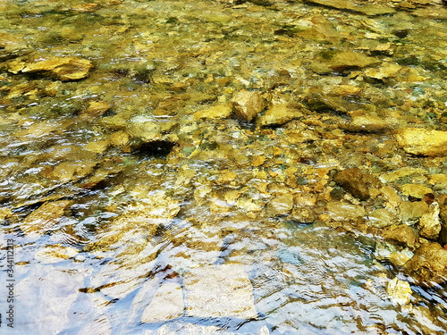 gold stones in water
