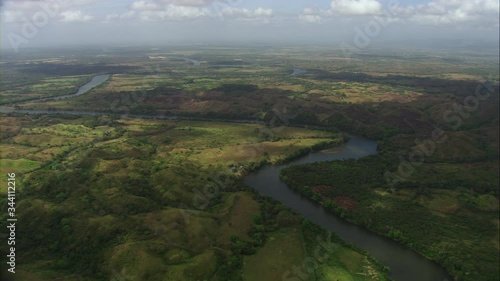 aerial view of green forests horizon, slopes, lake, the natural reservoir at noon. Shoot with Cineflex systems aerial view