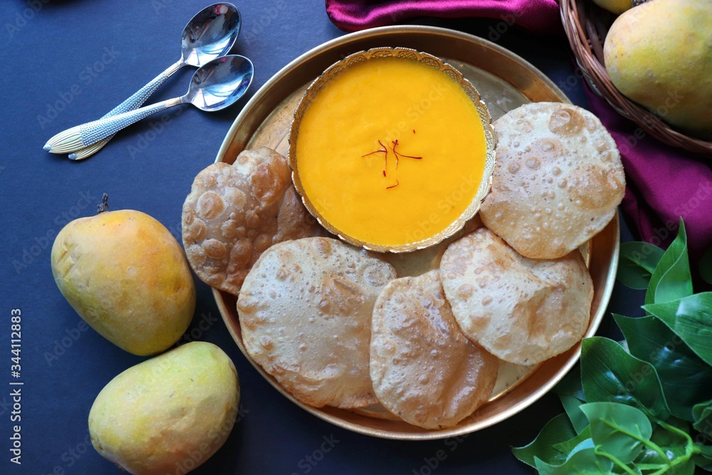 Indian Food Aamras is a sweet dish made from the pulp of the Alphonso mango fruit. Served with