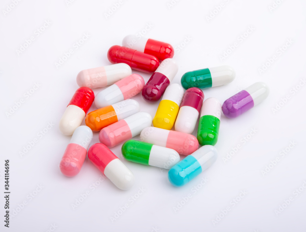 Different color pills on white background Different color pills on white background