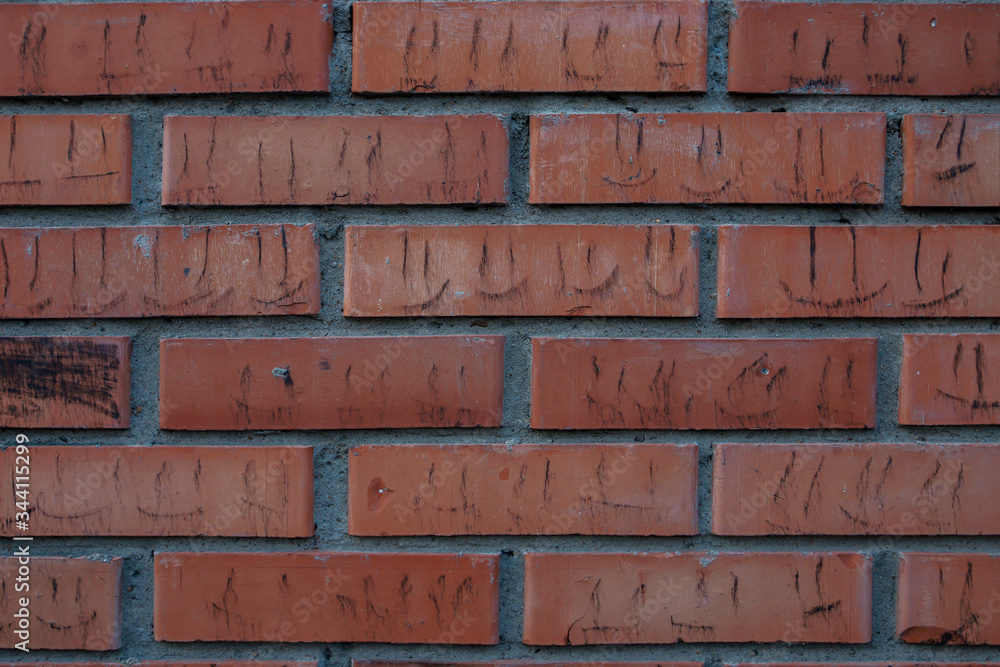Fototapeta premium brick wall background with black smileys