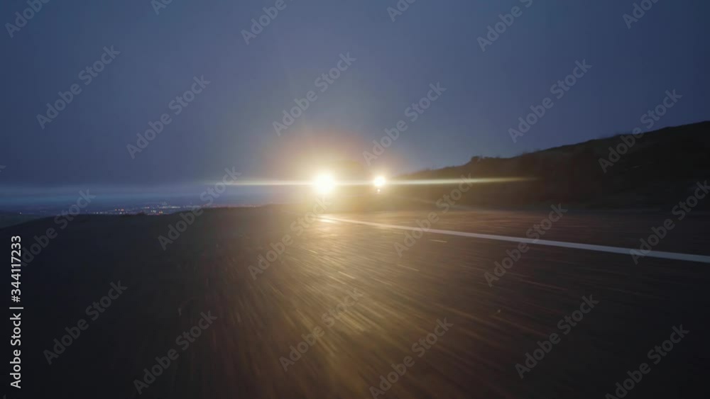 Low angle shot of high speed vintage car driving towards camera at blue ...