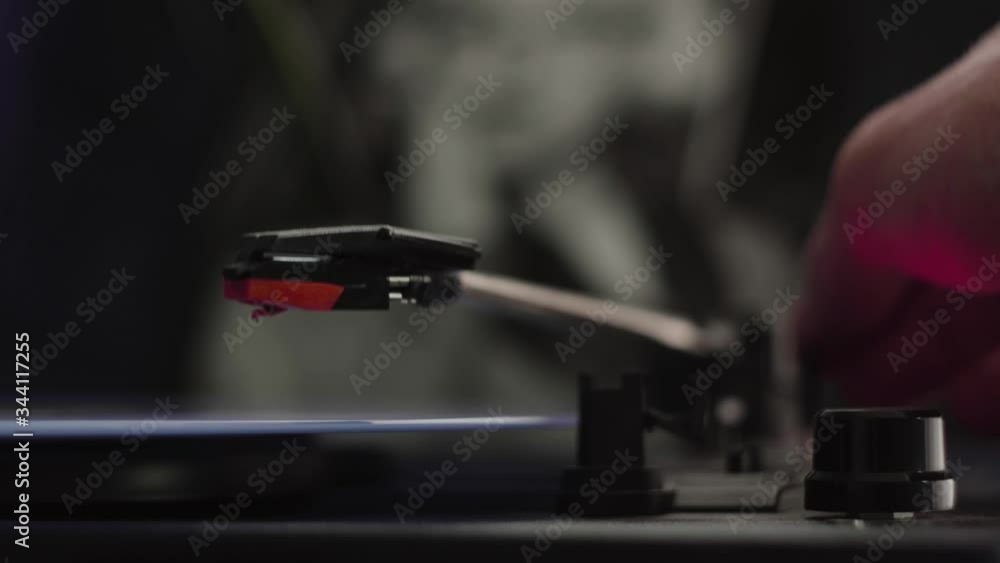 Close up shot of someone putting on a song on vinyl record on record player. Needle touches record to play music. Close up shot of someone putting on a song on vinyl record on record player. Needle touches record to play music.