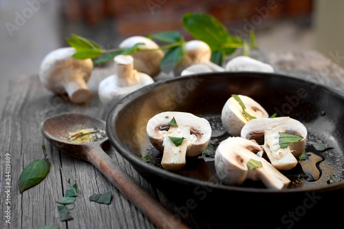 fresh organic mushrooms in a frying pan