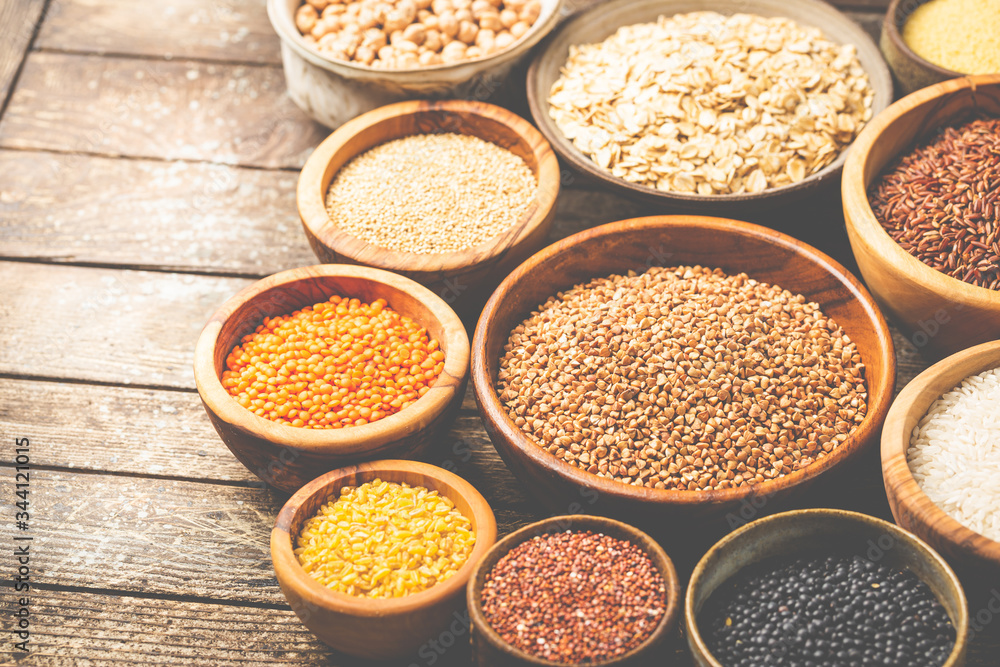 Organic products. Bowls with different gluten free grains on wooden background Organic products. Bowls with different gluten free grains on wooden background