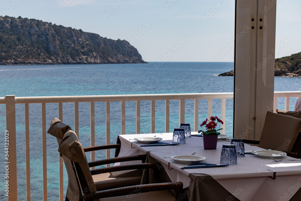 beautiful laid table in a restaurant overlooking the mediterranean sea in sant elm, mallorca, spain