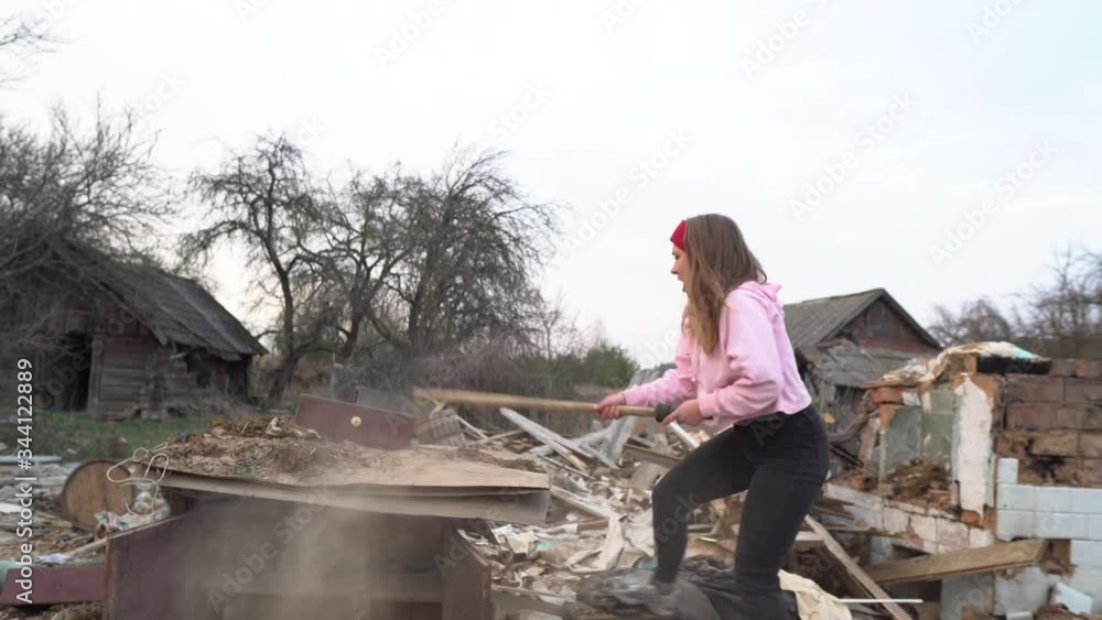 The woman punches and screams. The girl smashes everything around. A woman with a stick breaks it.Girl get angry. A very strong woman. Aggressive woman.Feminism. The woman punches and screams. The girl smashes everything around. A woman with a stick breaks it.Girl get angry. A very strong woman. Aggressive woman.Feminism.