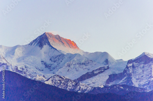 snow covered mountains with morning colour