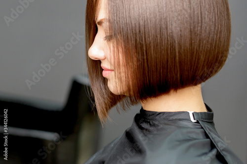 Woman with short hairstyle in hair salon with copy space. photo