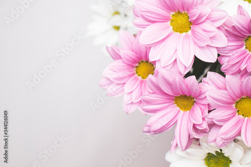 Background with an inscription field and a bright bouquet of gerberas in the corner. A bouquet of gerberas, creating an upbeat spring mood. © Mikhail