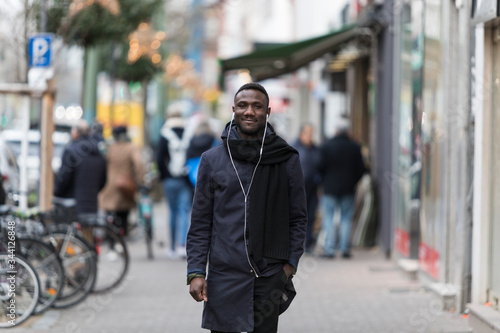 Young Black Man Walking Happily in City Smiling