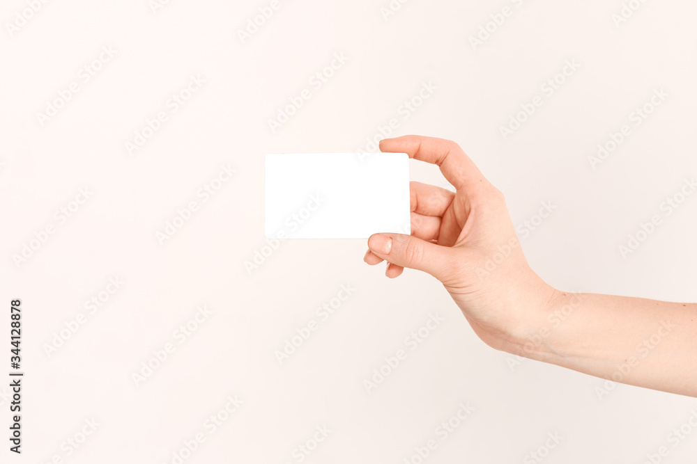 A beautiful female hand holds a Bank credit card with an online service, after completing the documents. A beautiful female hand holds a Bank credit card with an online service, after completing the documents.
