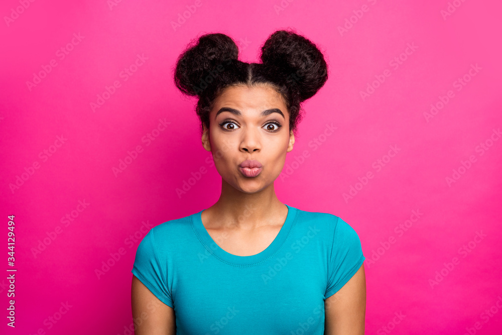 Closeup photo of beautiful pretty dark skin lady two buns hairdo send air kiss handsome guy good mood wear blue casual t-shirt isolated vivid pink color background Closeup photo of beautiful pretty dark skin lady two buns hairdo send air kiss handsome guy good mood wear blue casual t-shirt isolated vivid pink color background