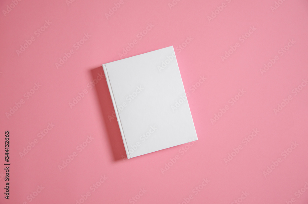 Mockup of closed blank square book at white textured paper Mockup of closed blank square book at white textured paper