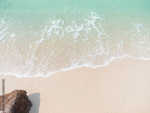 Beach blue sea with white soft wave and stone for travel or summer holiday. Ocean koh lan thailand.