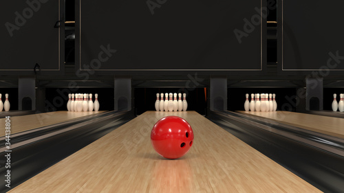 Red bowling ball on a wooden track with pins photo