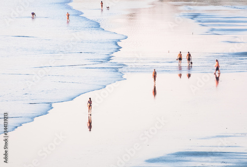 People walk on the beach