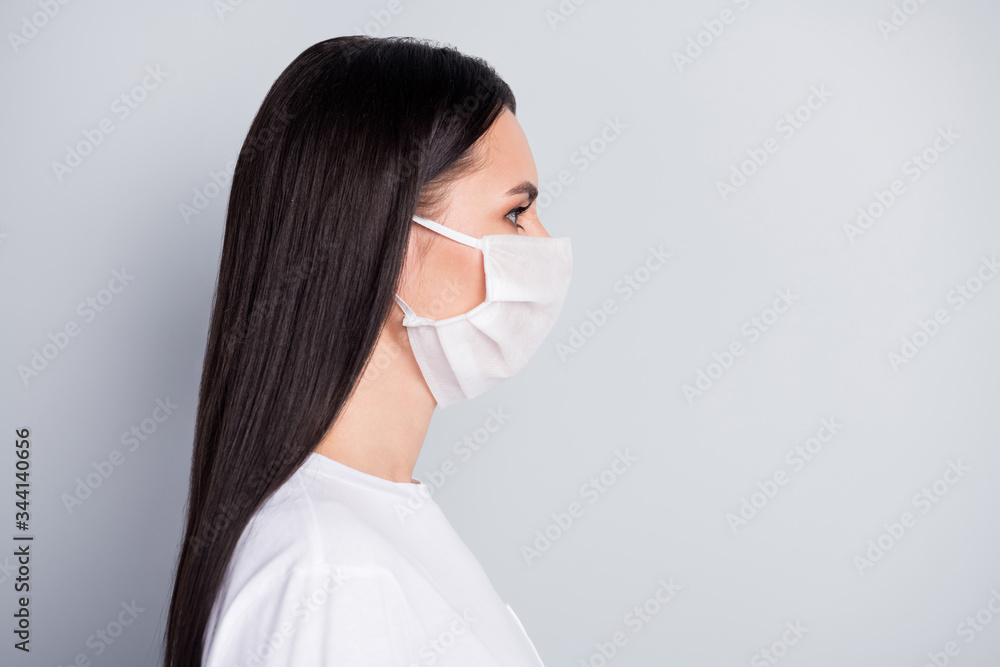 Profile side photo of strict girl in medical mask look copyspace have self-isolation not get corona virus sick wear stylish clothes isolated over gray color background Profile side photo of strict girl in medical mask look copyspace have self-isolation not get corona virus sick wear stylish clothes isolated over gray color background