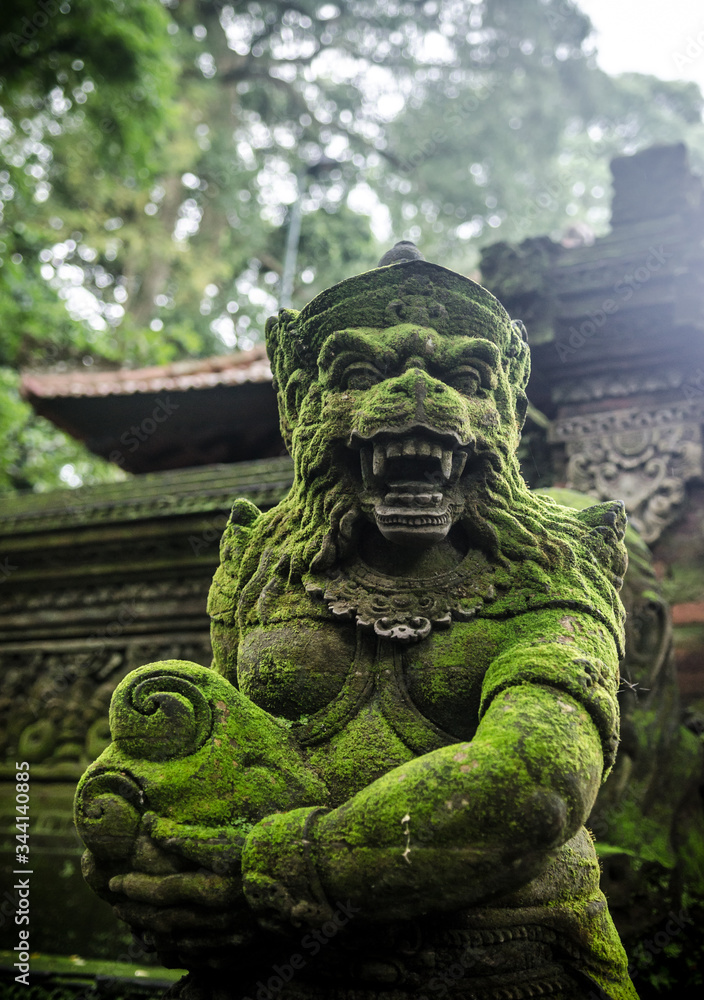 ancient statue in monkey forest bali indonesia