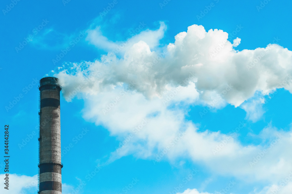 Environmental pollution, environmental problem, smoke from the chimney of an industrial plant or thermal power plant against a cloudy sky Environmental pollution, environmental problem, smoke from the chimney of an industrial plant or thermal power plant against a cloudy sky
