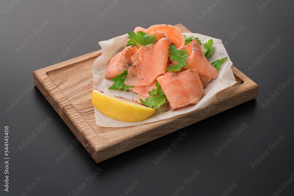 Smoked wild salmon with lemon on wooden background Smoked wild salmon with lemon on wooden background