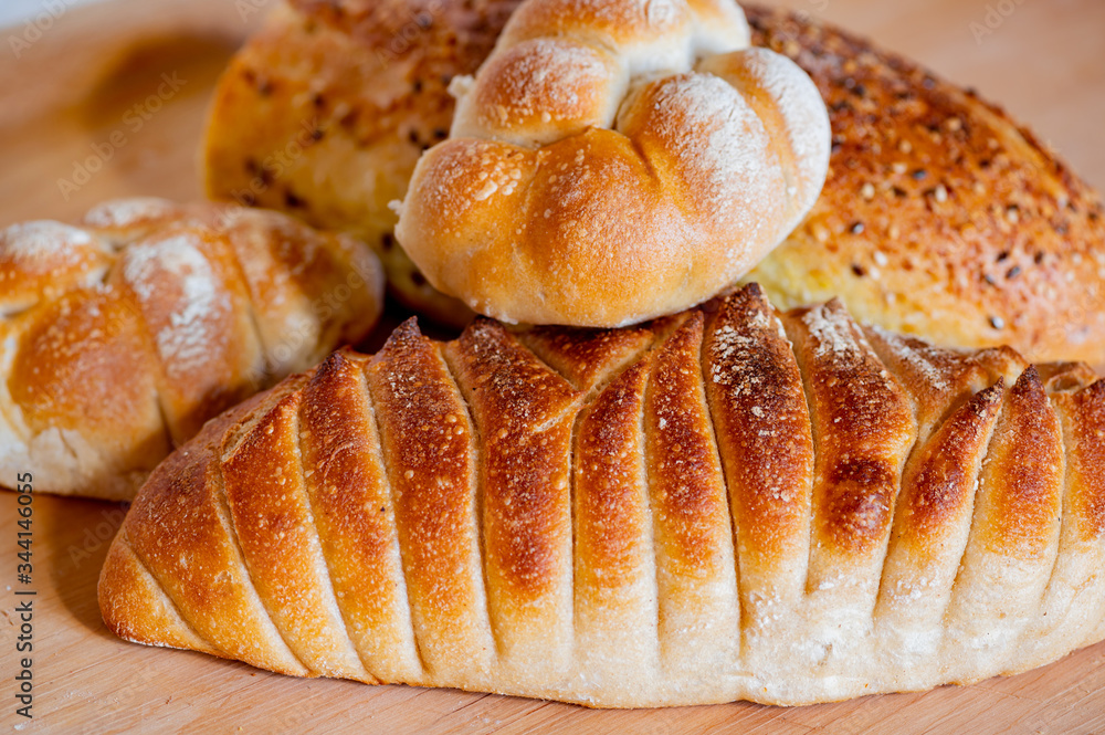 Freshly baked loaf of bread, buns, closeup.