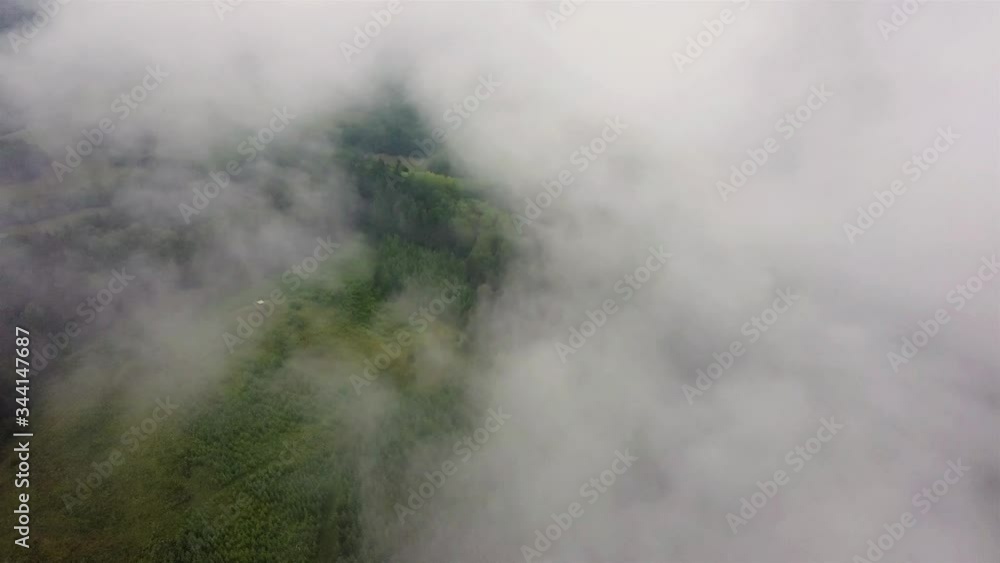 Aerial view of coniferous forest through clouds in a mountainous region of Slovakia, Tatra Mountains