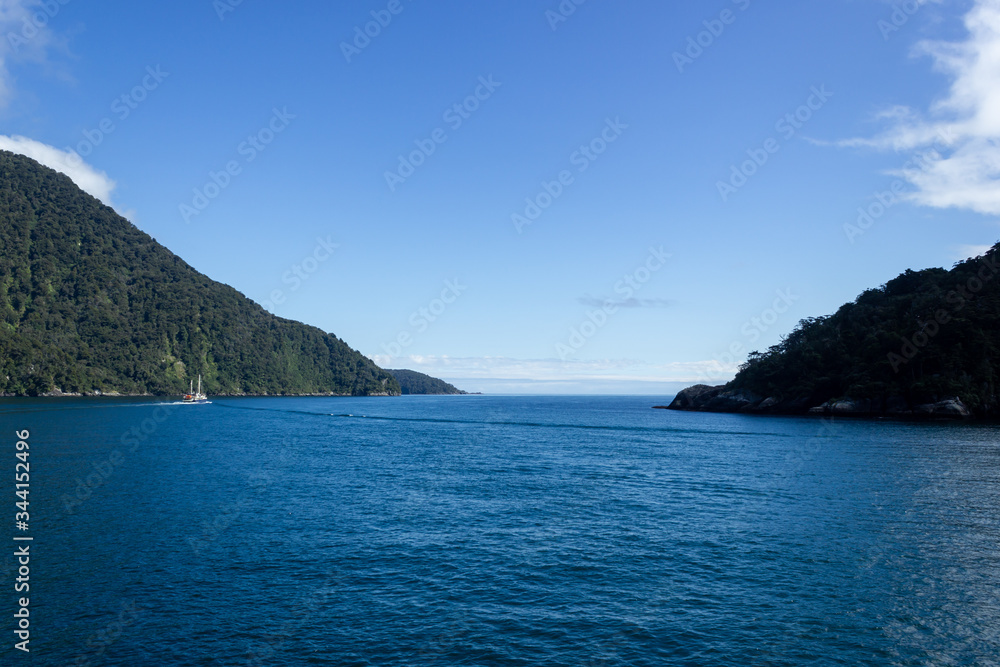 Milford Sound on a ferry on a beautiful blue sky day, Fiordland, South Island,New Zealand. Milford Sound on a ferry on a beautiful blue sky day, Fiordland, South Island,New Zealand.