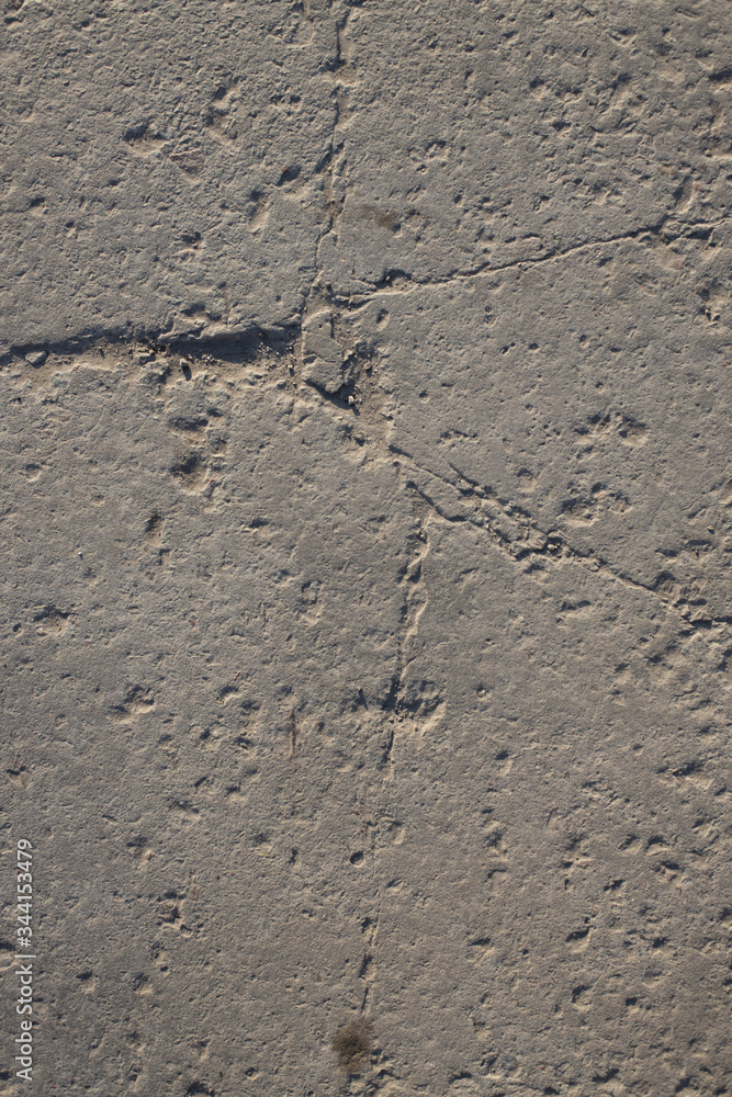 The texture of the broken road. Old building blocks. Background for screensaver monitor The texture of the broken road. Old building blocks. Background for screensaver monitor