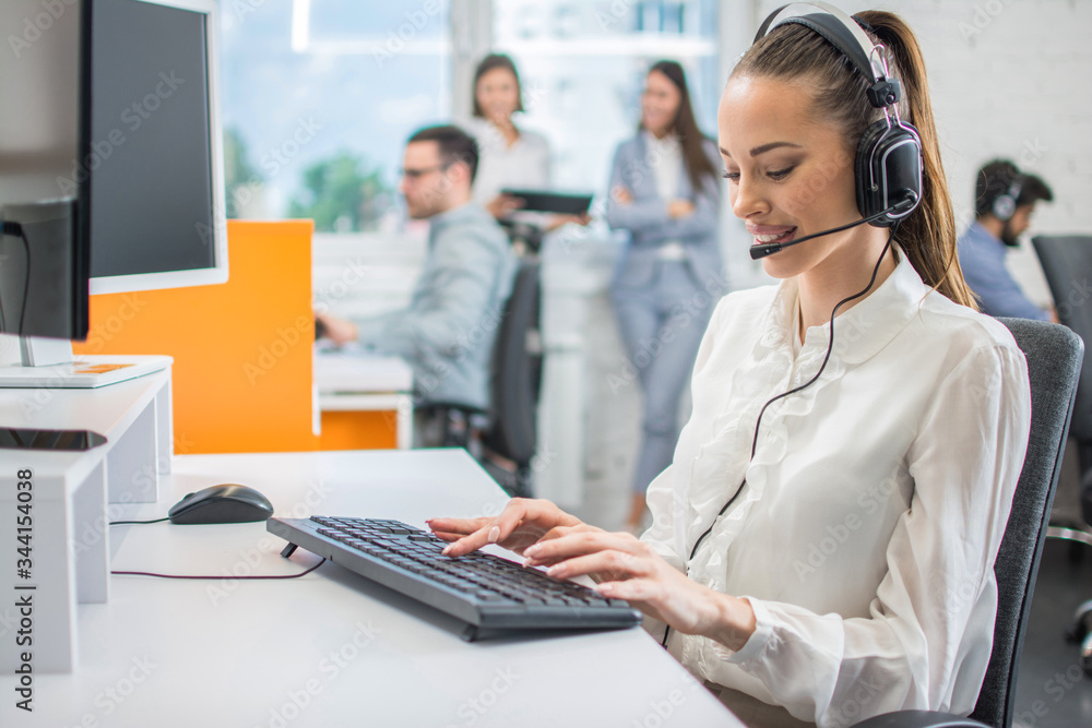 Portrait of female customer support or sales agent. Caller or receptionist phone operator working in call center. Portrait of female customer support or sales agent. Caller or receptionist phone operator working in call center.