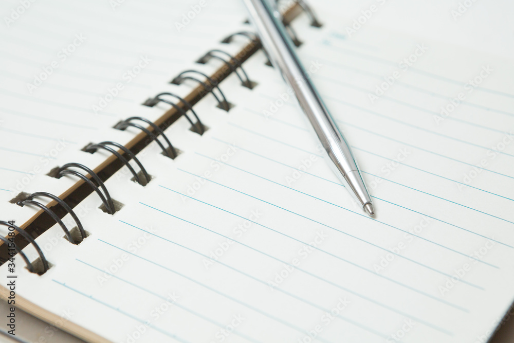 Selective focus of Pen, notebook on white background Selective focus of Pen, notebook on white background