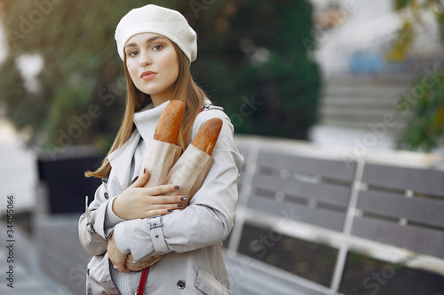 Girl with a baguette. Woman in a white beret. Lady in a french style.