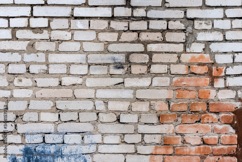 Fototapeta premium Background of an old, dirty, white brick wall with peeling plaster, painted walls, texture