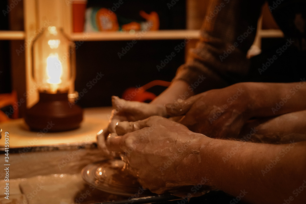 Lovers on a date sculpts jug. Potter's hands