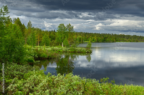 Picturesque summer landscape with heavy thunderclouds. Finnish Lapland, Suomi photo