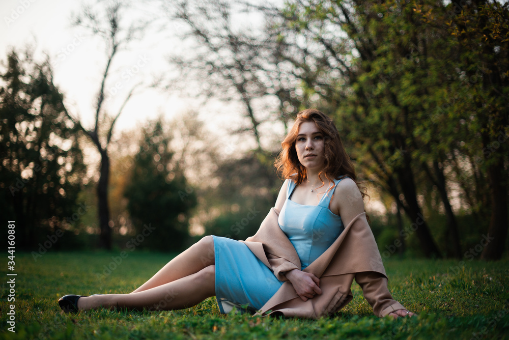 Beautiful young girl in a blue dress in a spring park Beautiful young girl in a blue dress in a spring park