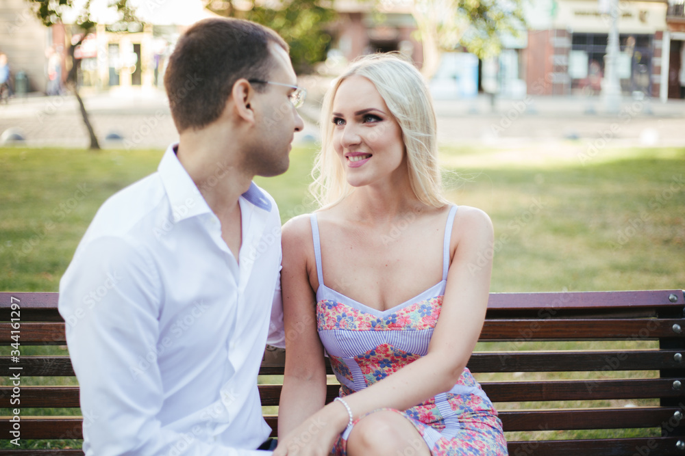 Obraz premium sitting on a bench in the city. couple in love